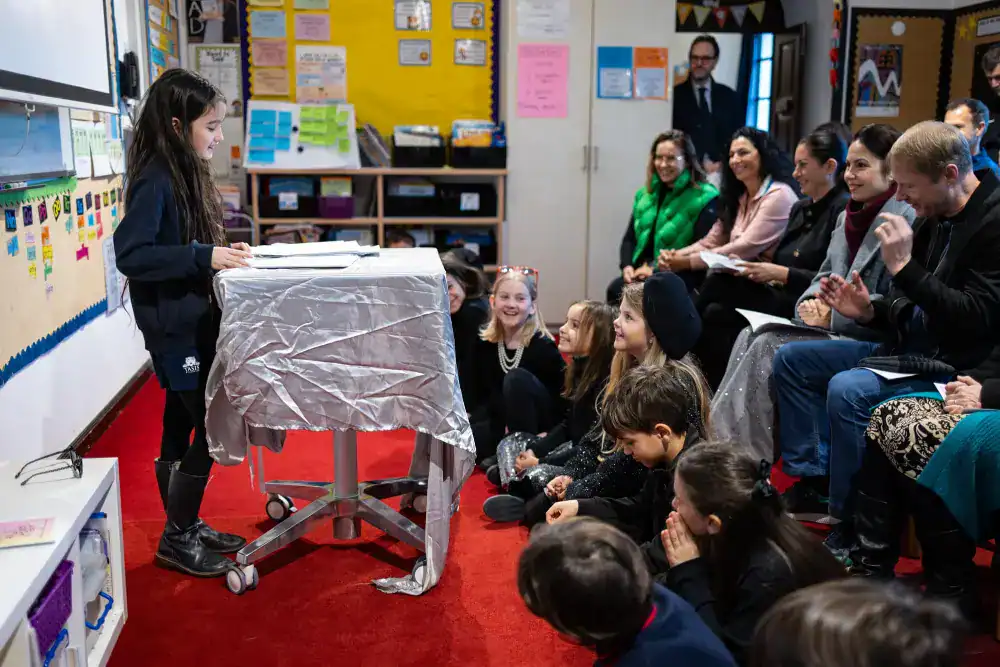 This Month at TASIS: March 2025 16 Engaging classroom presentation at a world school with students and teachers participating actively.