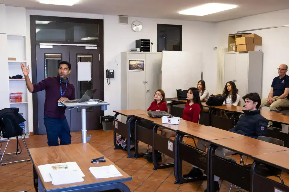 This Month at TASIS: March 2025 18 Modern classroom at World Schools with diverse students attending an engaging lesson.