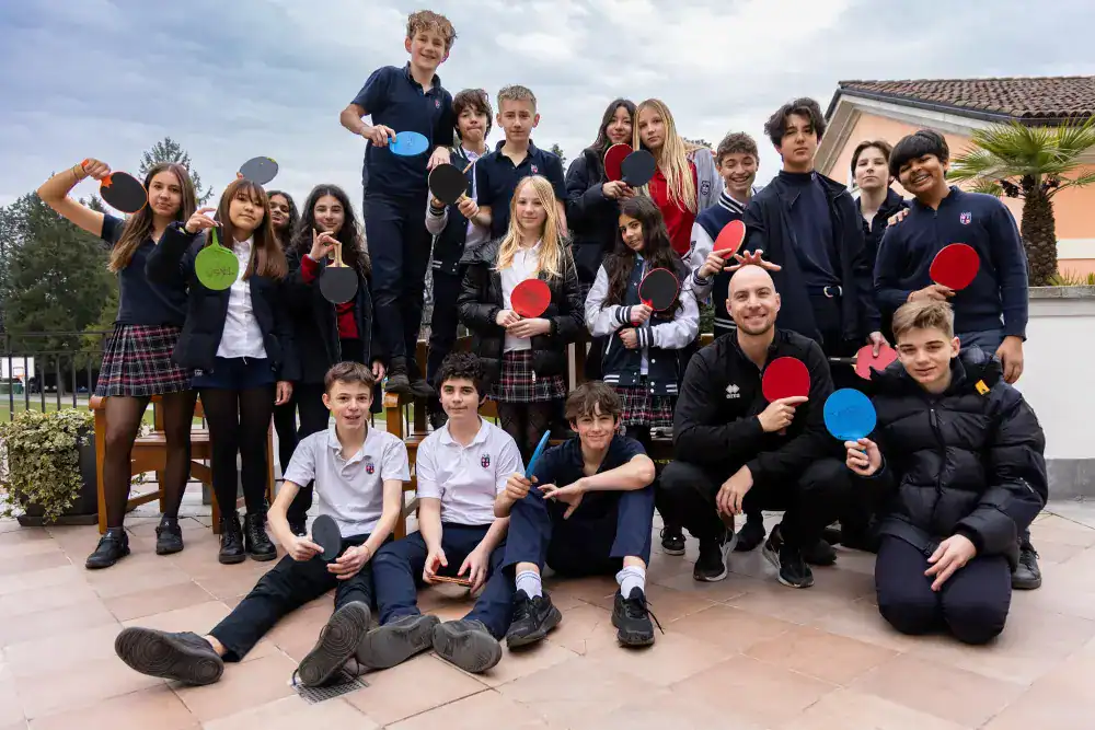 This Month at TASIS: March 2025 20 Young students playing table tennis outdoors at World Schools.