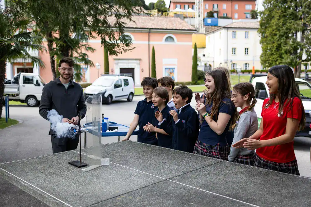 This Month at TASIS: April 2025 3 Children engaging in science experiments at a world school outdoor activity.