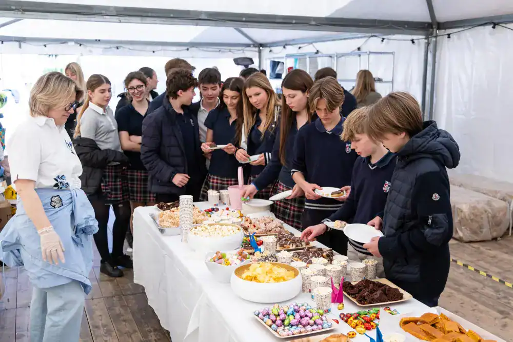 This Month at TASIS: April 2025 6 Students enjoying a dessert buffet at a school event, showcasing diverse activities at World Schools.