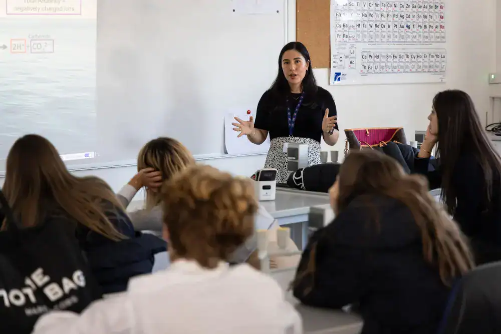 This Year at TASIS: 2024 9 Engaging classroom scene with teacher and students in a modern school setting.