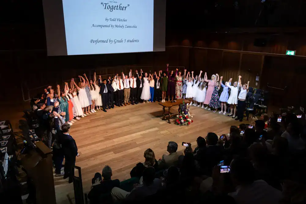 This Year at TASIS: 2024 26 Students performing on stage at a World Schools event, celebrating cultural diversity and academic excellence.