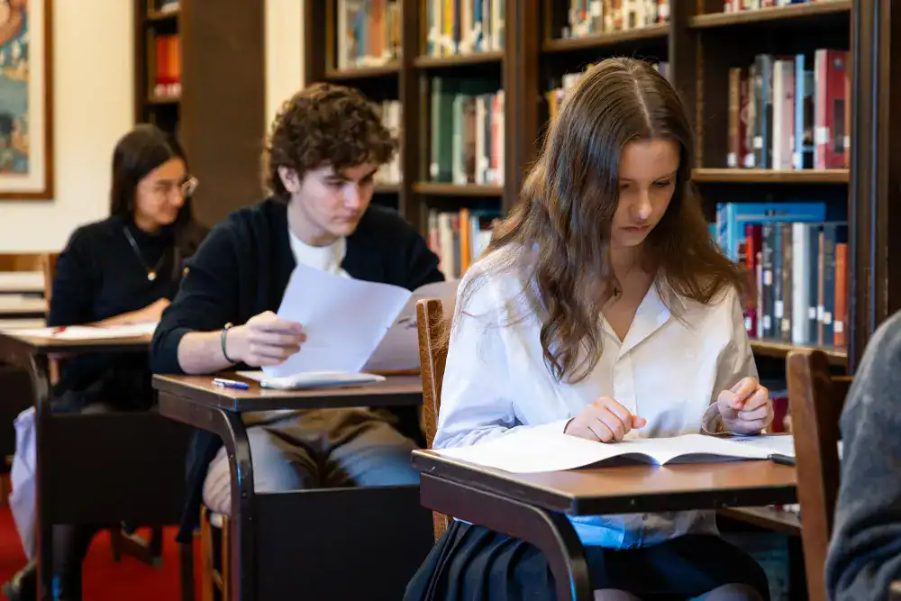 This Year at TASIS: 2024 28 Young students studying in a library, focusing on their coursework at World Schools.