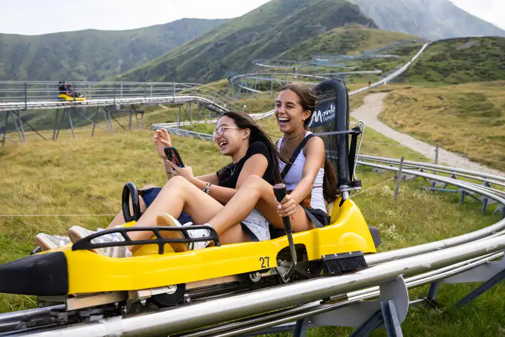 This Year at TASIS: 2024 30 Thrilling mountain coaster ride with smiling students enjoying outdoor adventure.