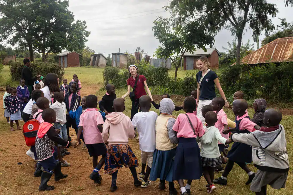 This Year at TASIS: 2024 7 Vibrant children playing outdoors in rural schoolyard, fostering community and cultural exchange.