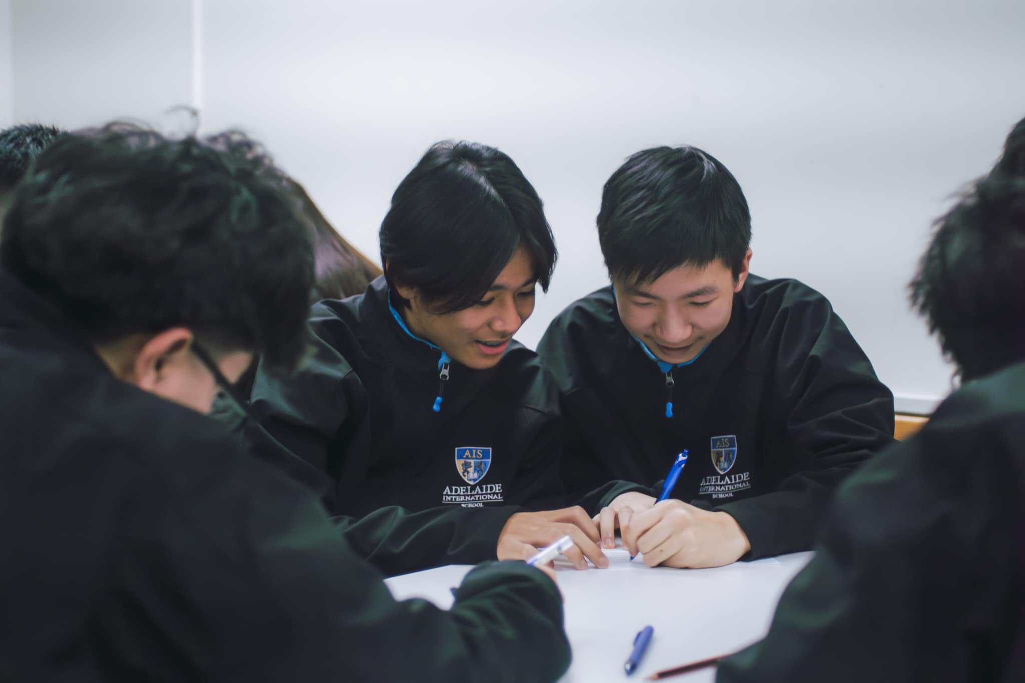 Highly engaged students studying together at Adelaide International School, promoting academic excellence and global education.