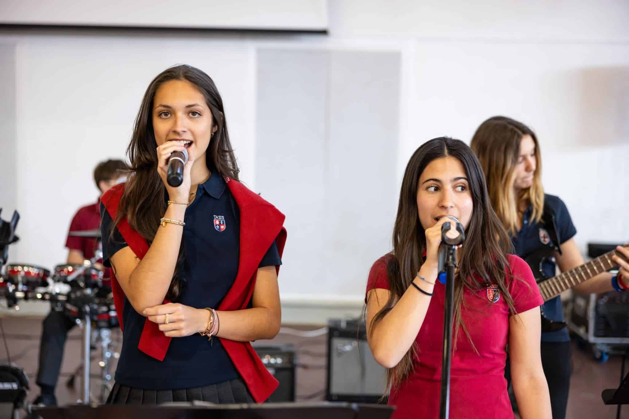 This Month at TASIS: May 2025 10 Young female students performing school band music at an international school event, showcasing talent and cultural diversity.