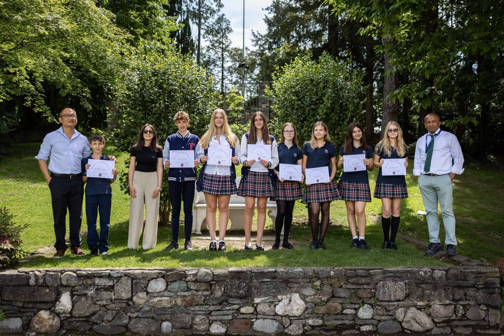 This Month at TASIS: May 2025 18 1. Group of students and teachers holding certificates outdoors at World Schools event.