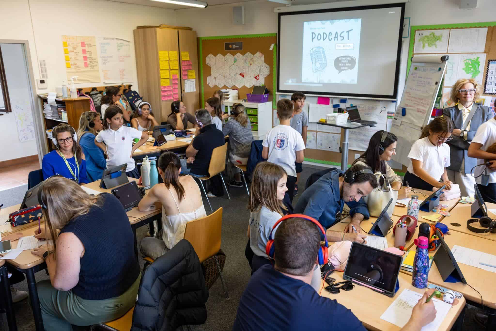 This Month at TASIS: May 2025 19 Students engaging in podcast recording activity at World Schools classroom.