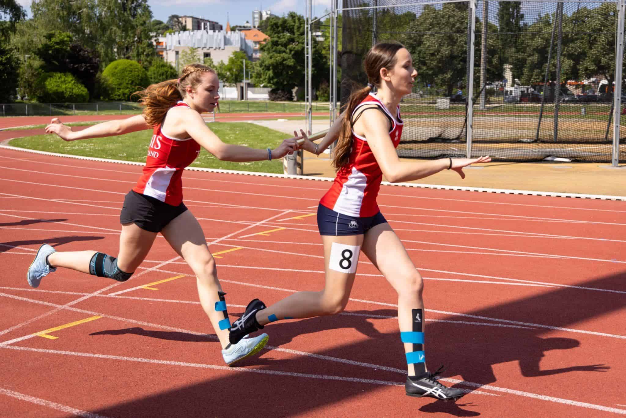 This Month at TASIS: May 2025 12 Running competition at a school sports day, with students wearing sports uniforms on a track field. Great teamwork and school spirit.