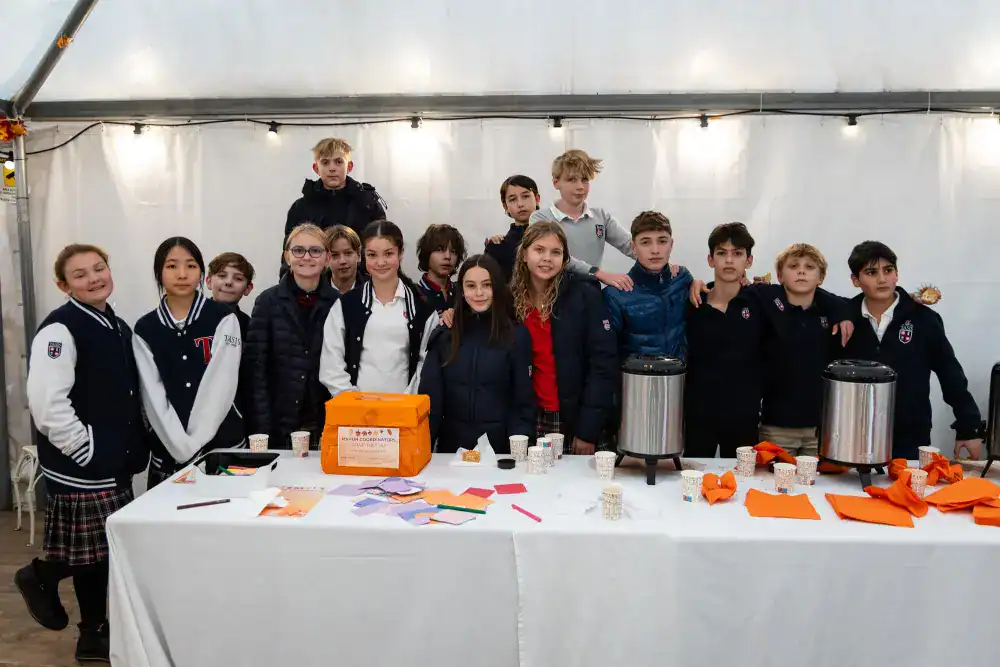 This Month at TASIS: November 2024 15 Young students at World Schools event enjoying group activities and community engagement.