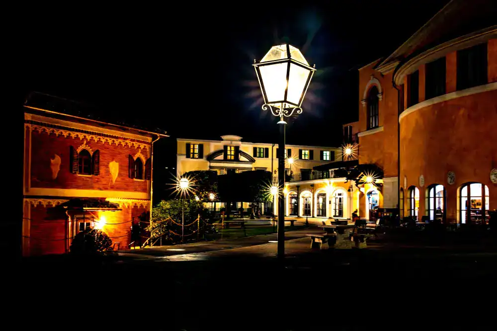This Month at TASIS: November 2024 16 European-style school campus illuminated at night with historic architecture and street lamps.
