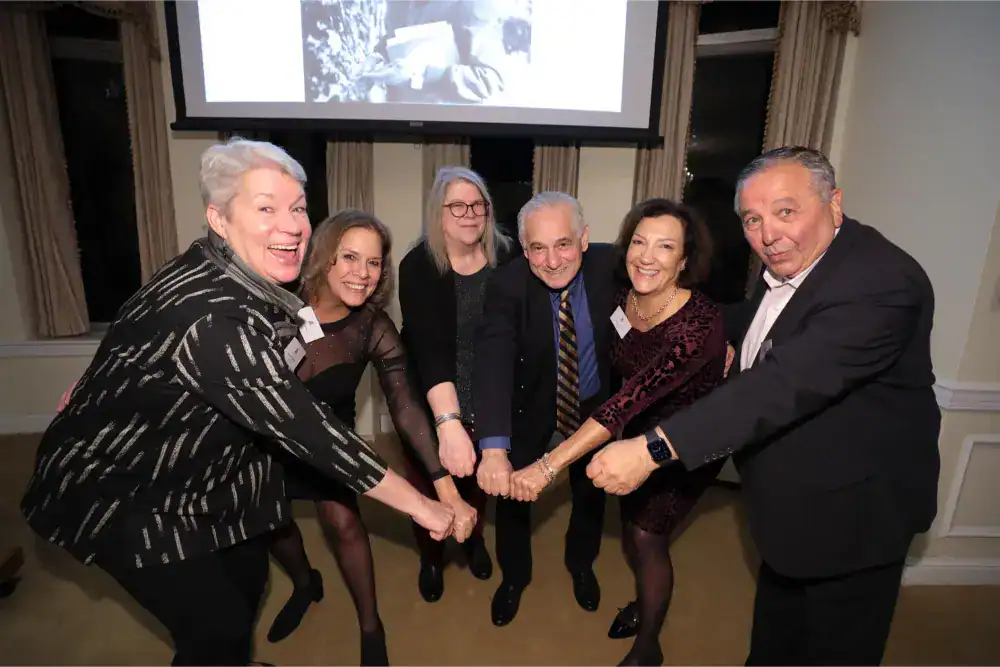 This Month at TASIS: November 2024 20 Smiling professionals at a World Schools event, emphasizing global education and collaboration.