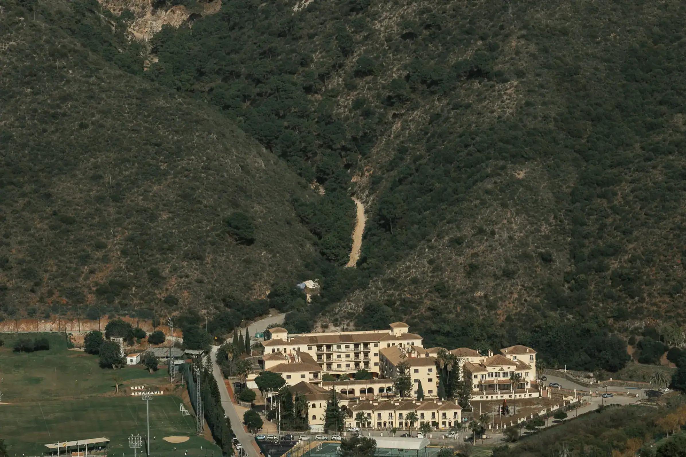 Secluded luxury resort nestled in mountain hillside offering panoramic views and upscale amenities.