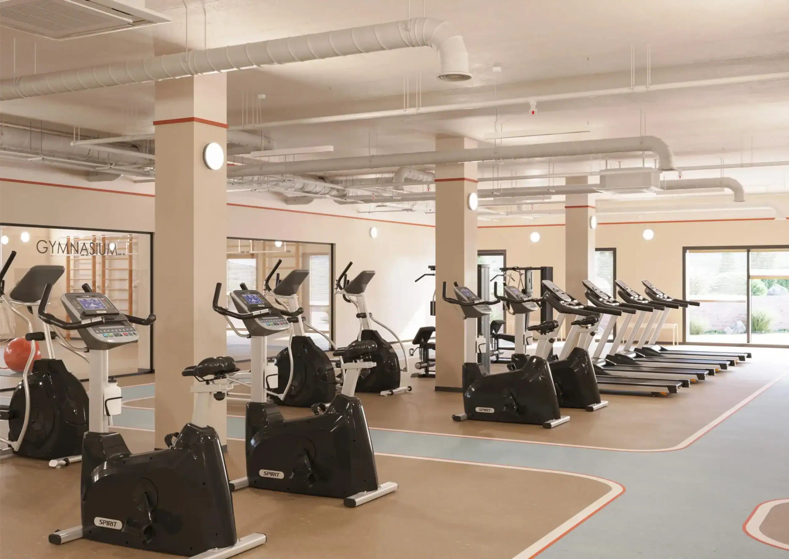 Modern school gym with cardio equipment and fitness area for students.