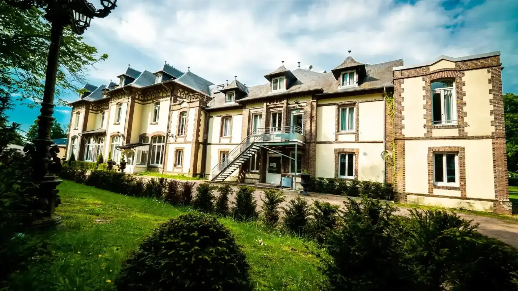 Elegant historic school building with lush greenery, ideal for international students seeking quality education.