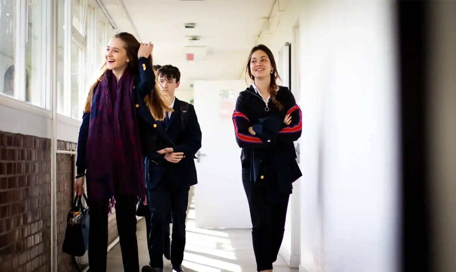 Bright students walking in a school corridor, enjoying a lively day at World Schools.