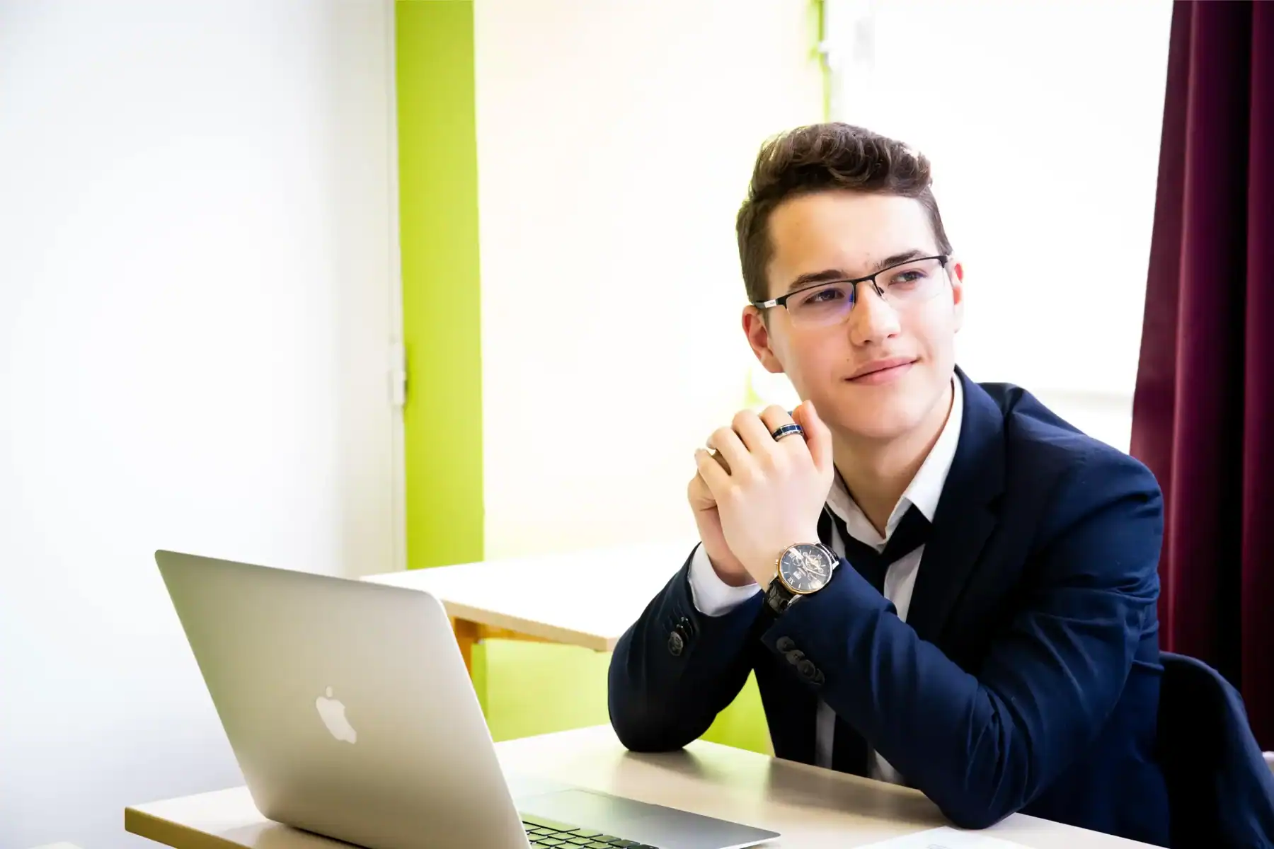 Bright young student studying at a modern school with a laptop, representing innovative education at World Schools.