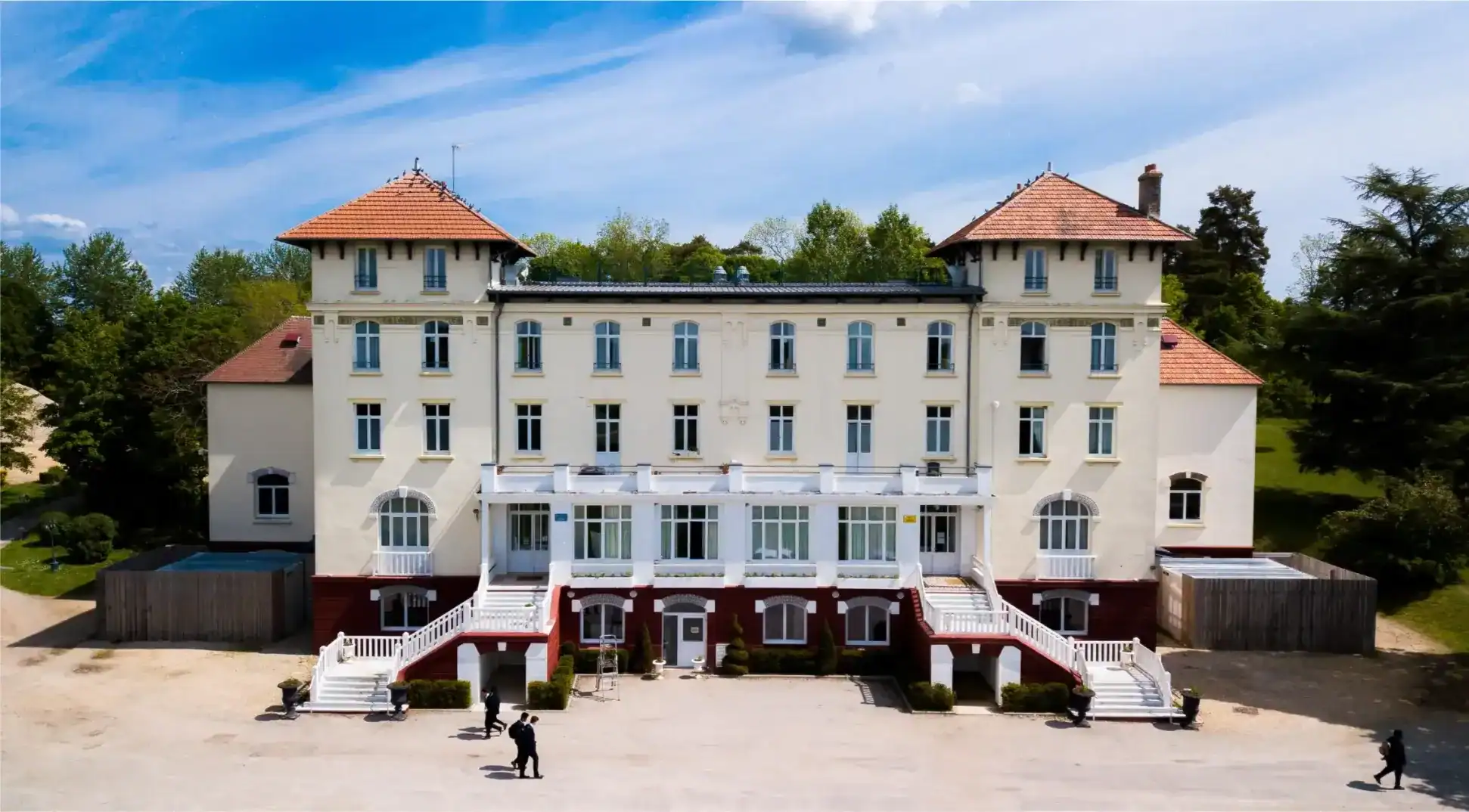 Elegant historic school building with classic architecture and surrounding greenery, ideal for international student programs.