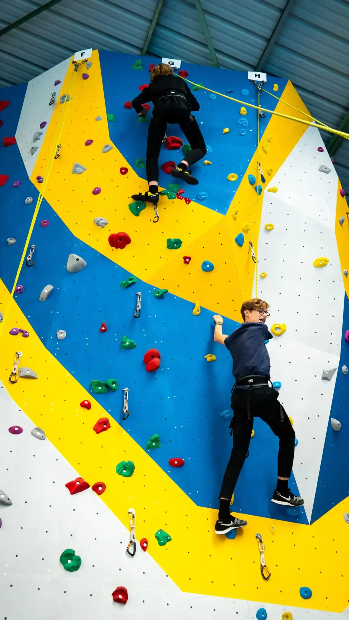 Colorful indoor rock climbing wall for children and teens at World Schools.