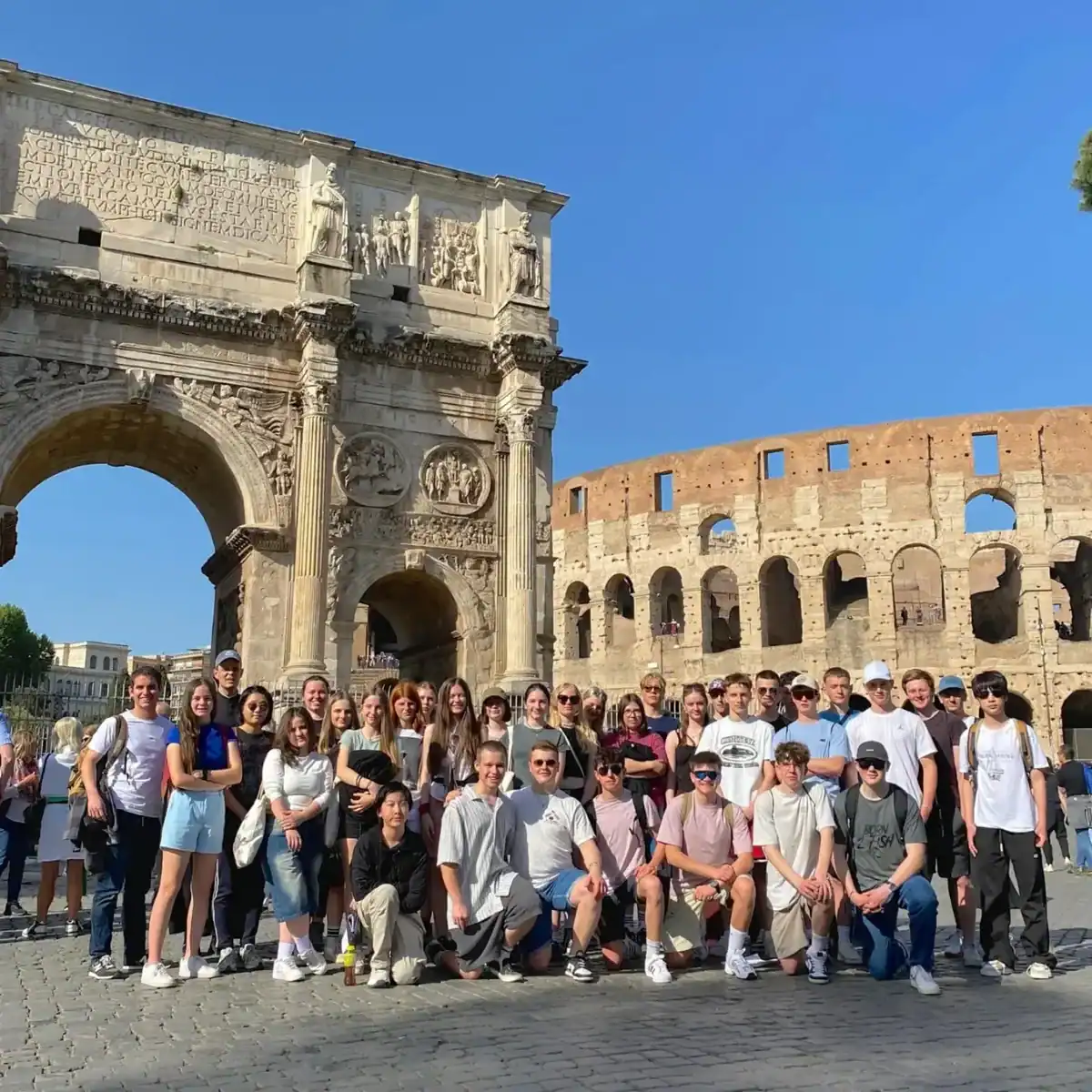 Historic Rome group tour with students at the Colosseum and Arch of Constantine.