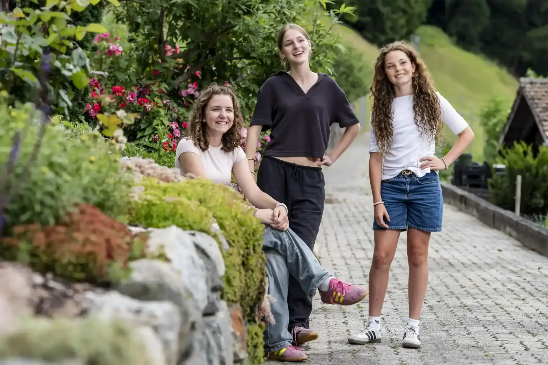 Brightly dressed girls enjoying outdoor greenery at a world school.