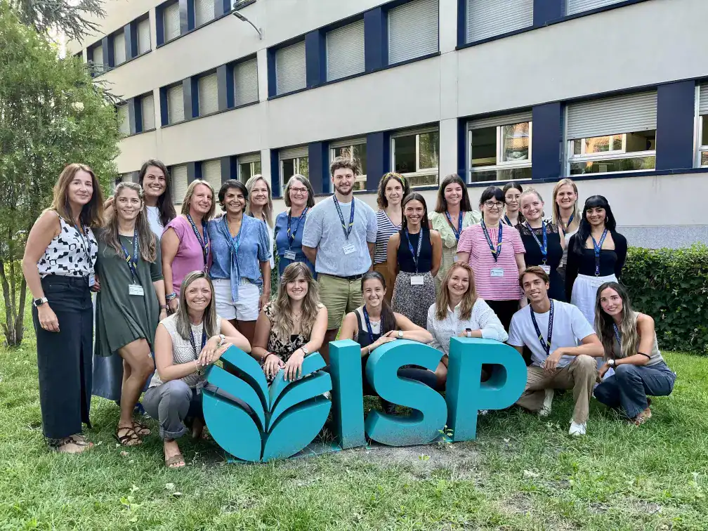 Diverse group of students and teachers outdoors at World Schools conference, promoting international education.