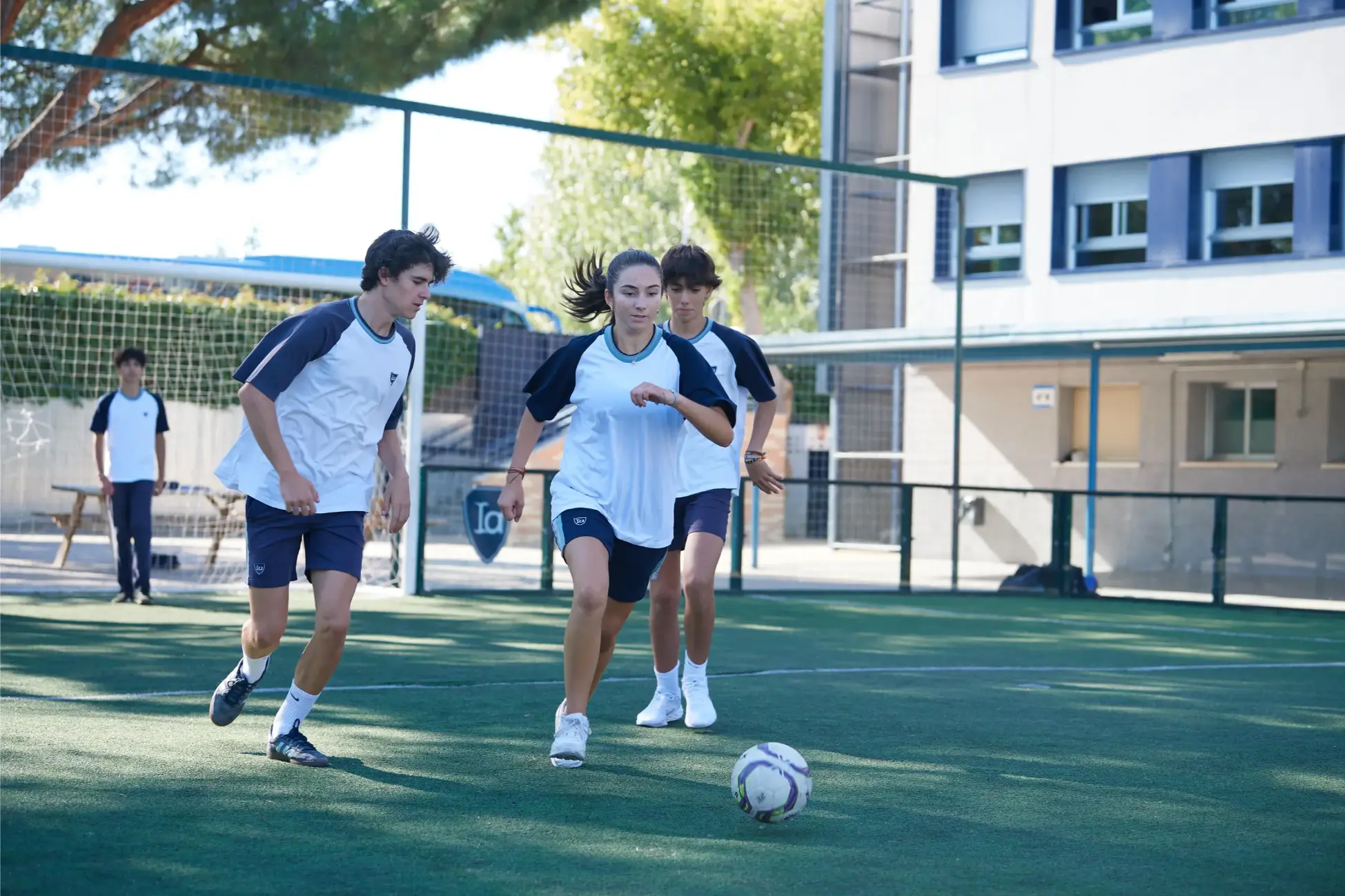 Young students playing soccer outdoors at World Schools campus.