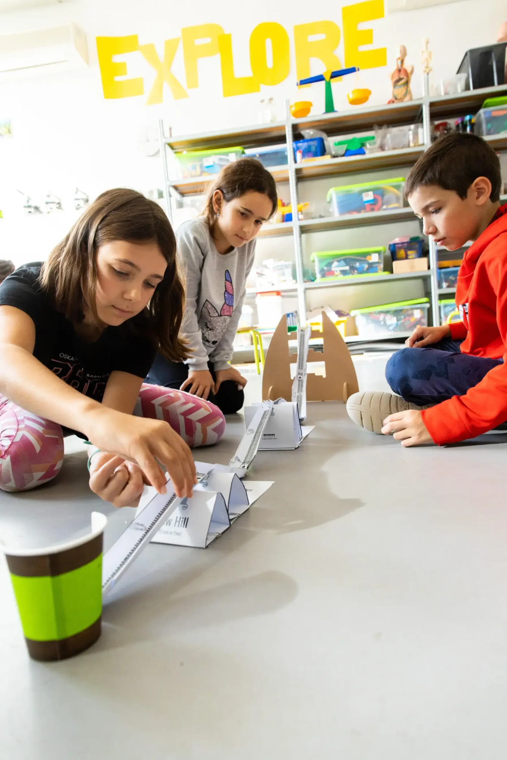 1. Children building a model track in a classroom for interactive learning experiences.
