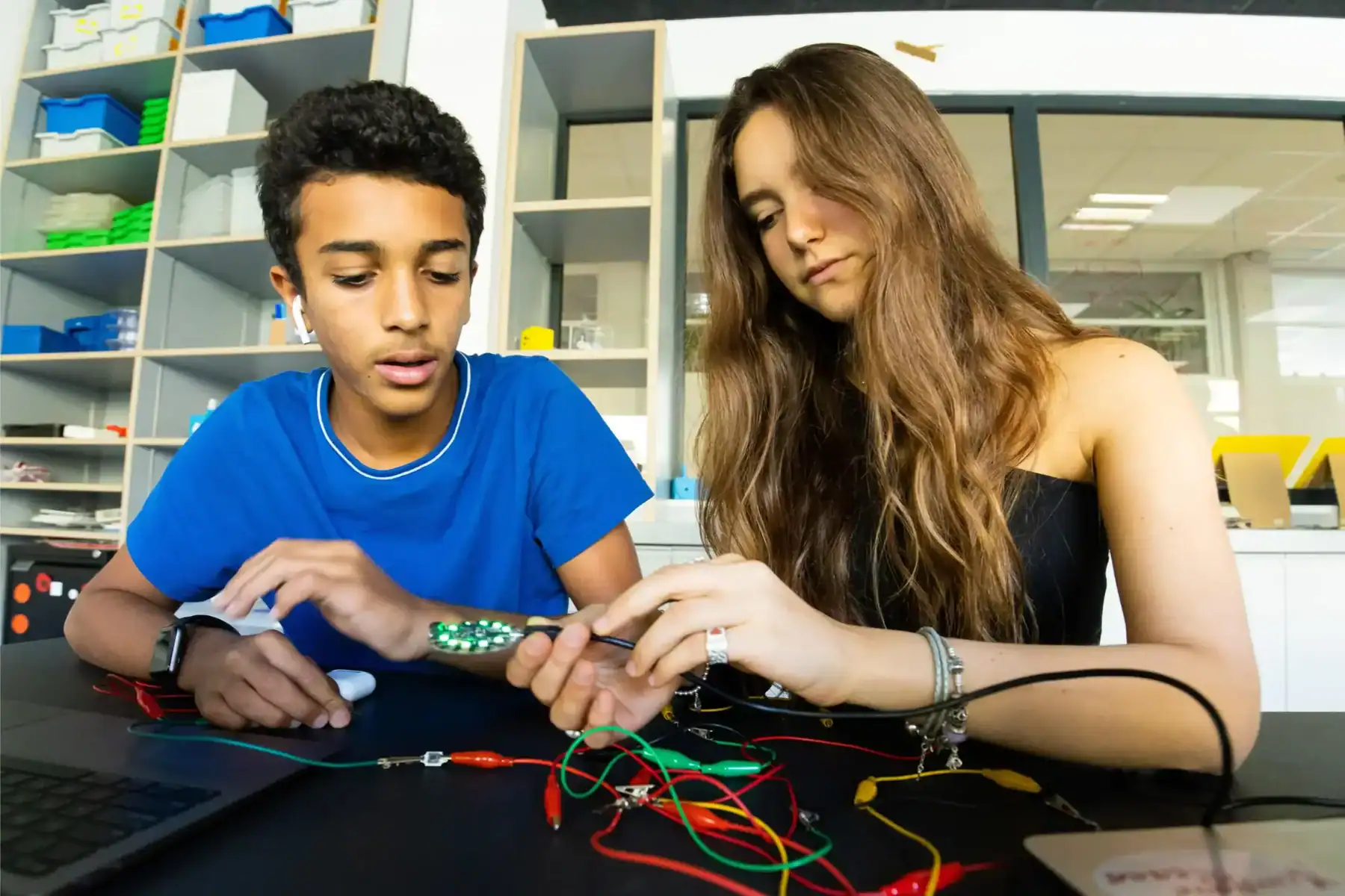 Young students working on STEM electronics project in a modern school laboratory.