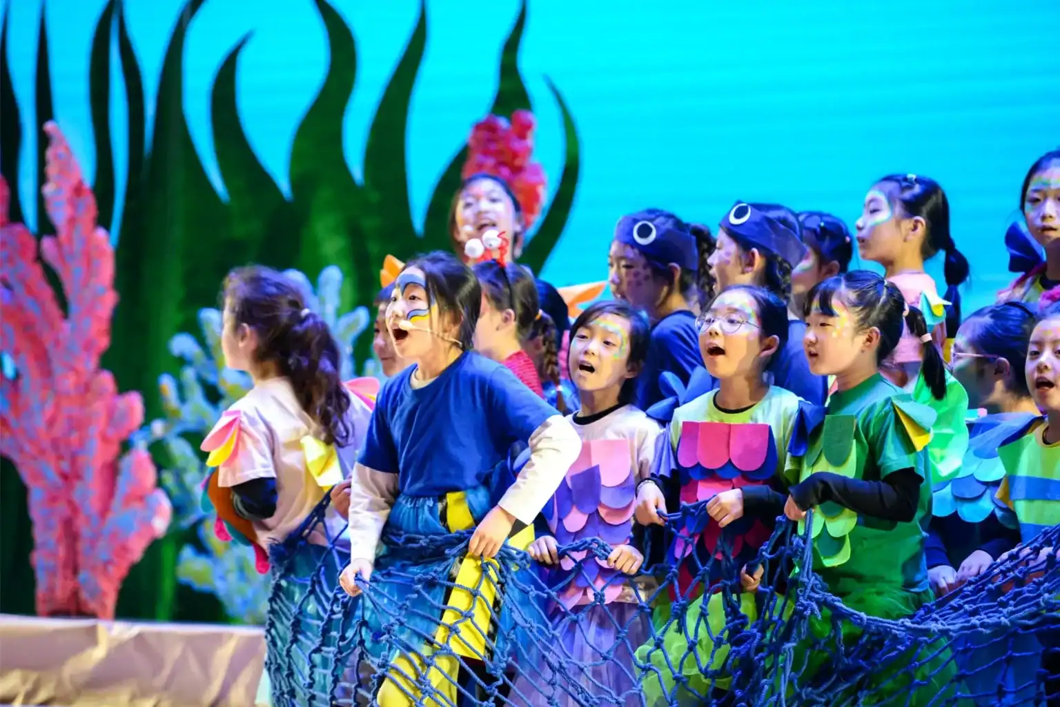 Children performing on stage at Dulwich College Suzhou school event.