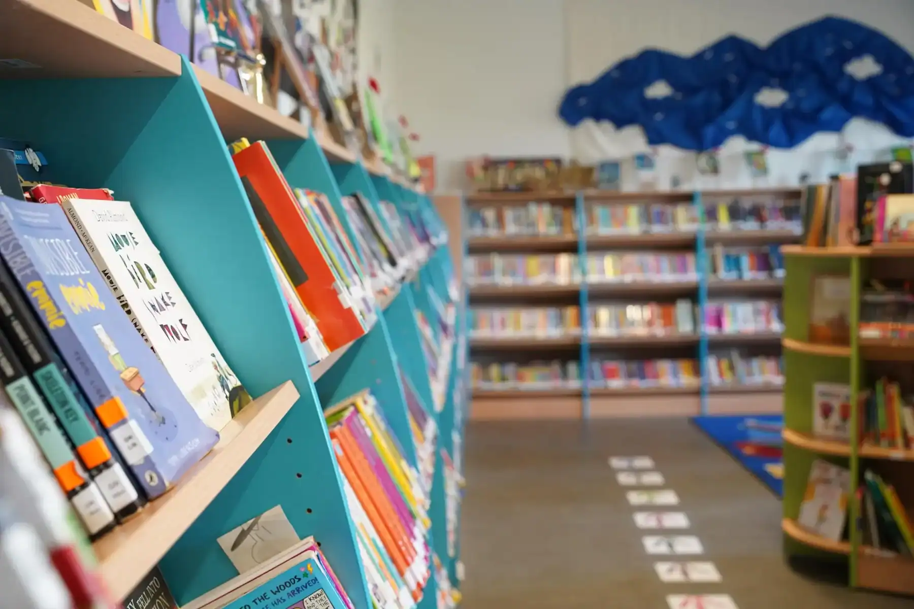 Bright school library with colorful bookshelves and educational materials.