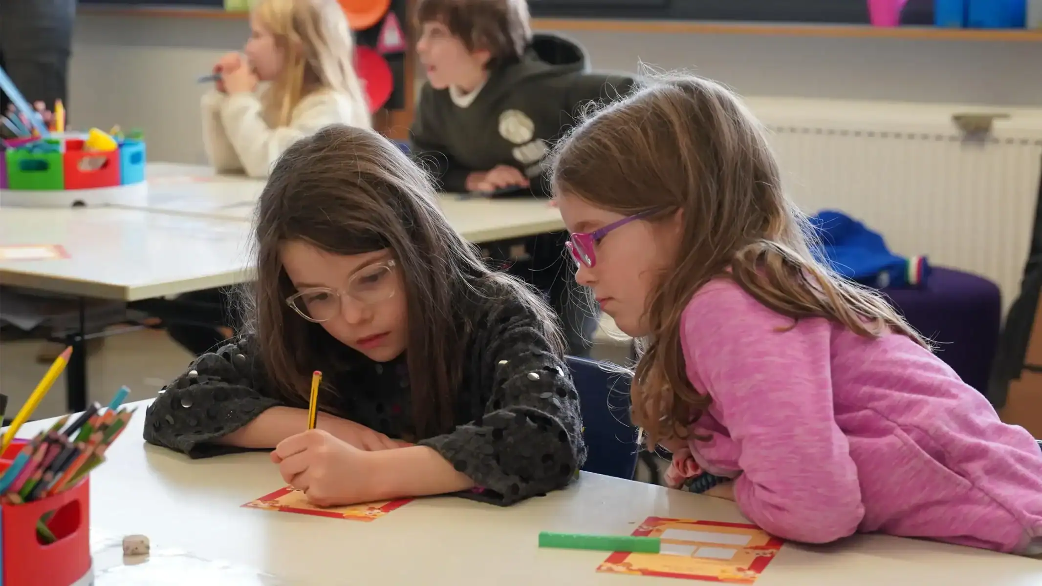 Two young girls studying together in a classroom at St George's International School, Luxembourg.