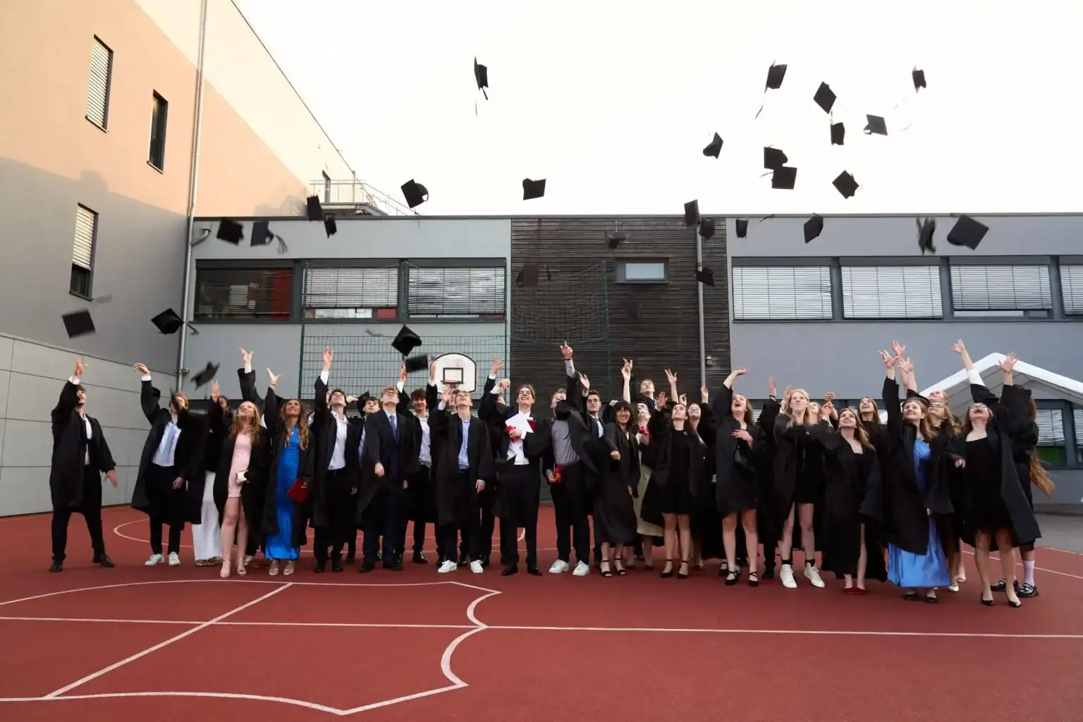 Graduates celebrating their graduation at St George's International School, Luxembourg.
