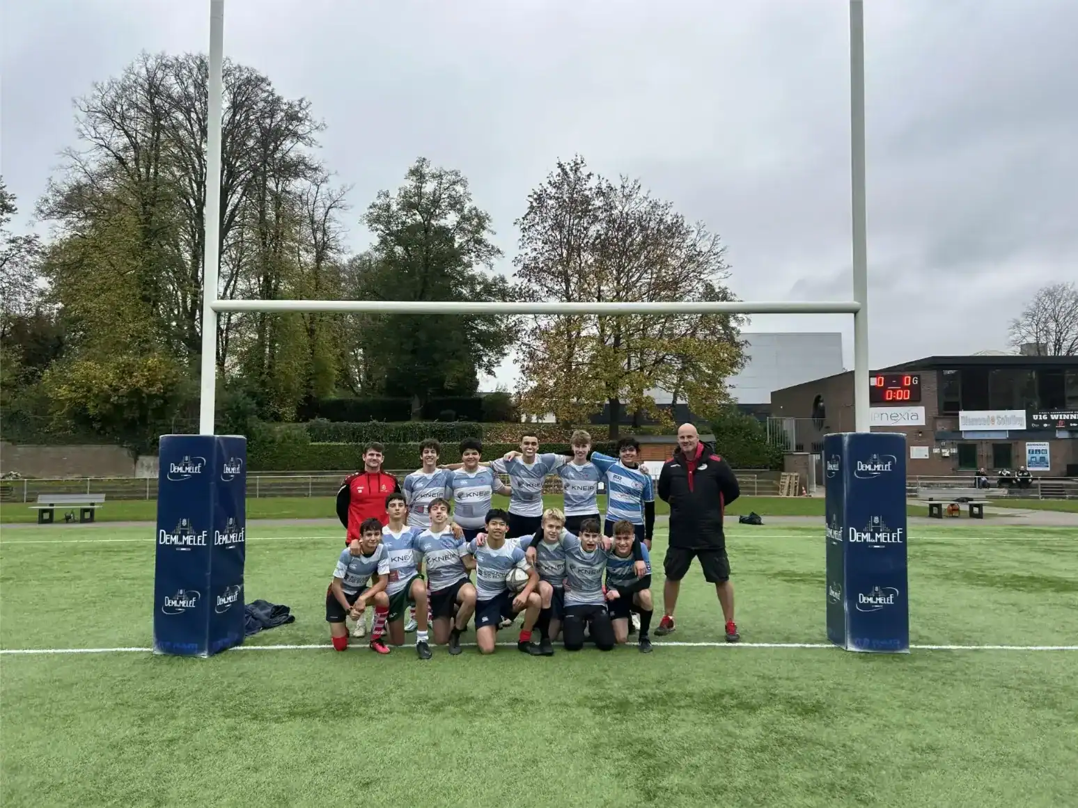 Young rugby players with coach at St George's International School Luxembourg.
