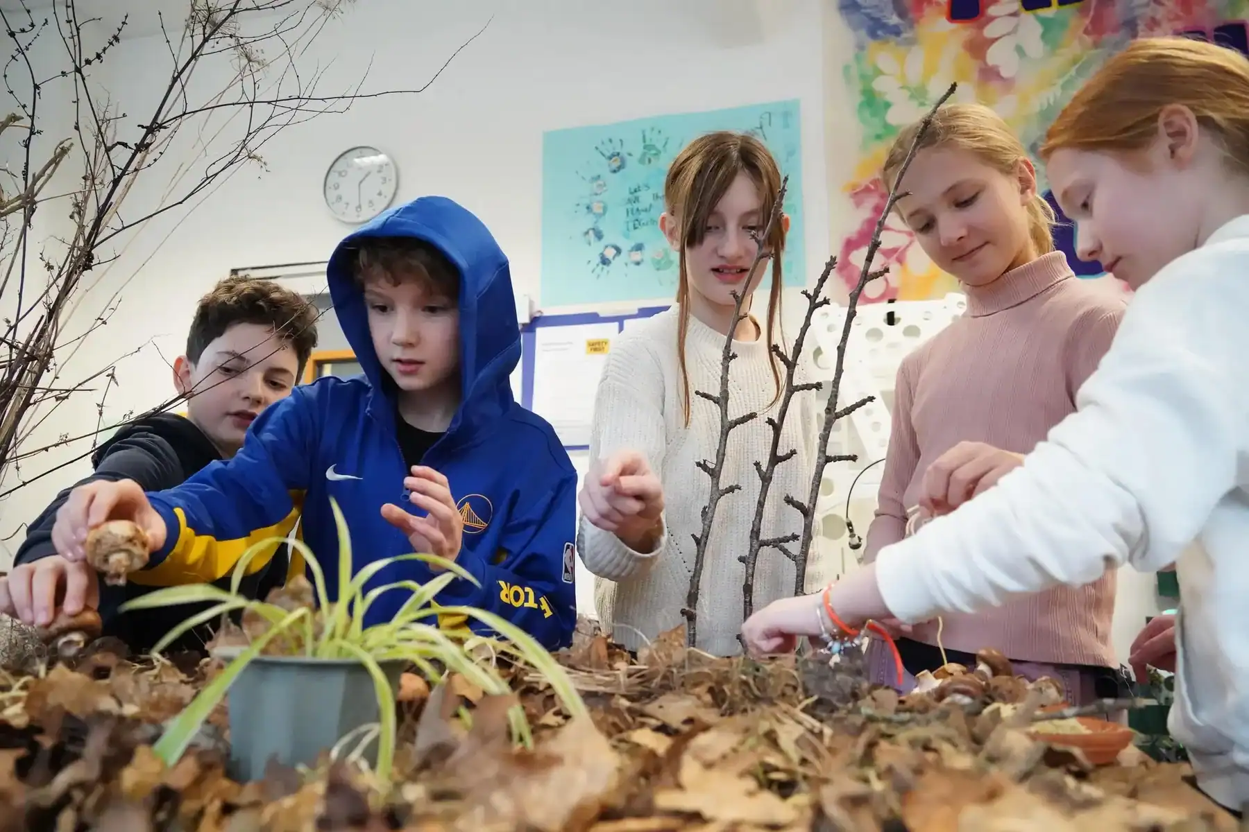 Children engaging in outdoor environmental activities at St George's International School, Luxembour.