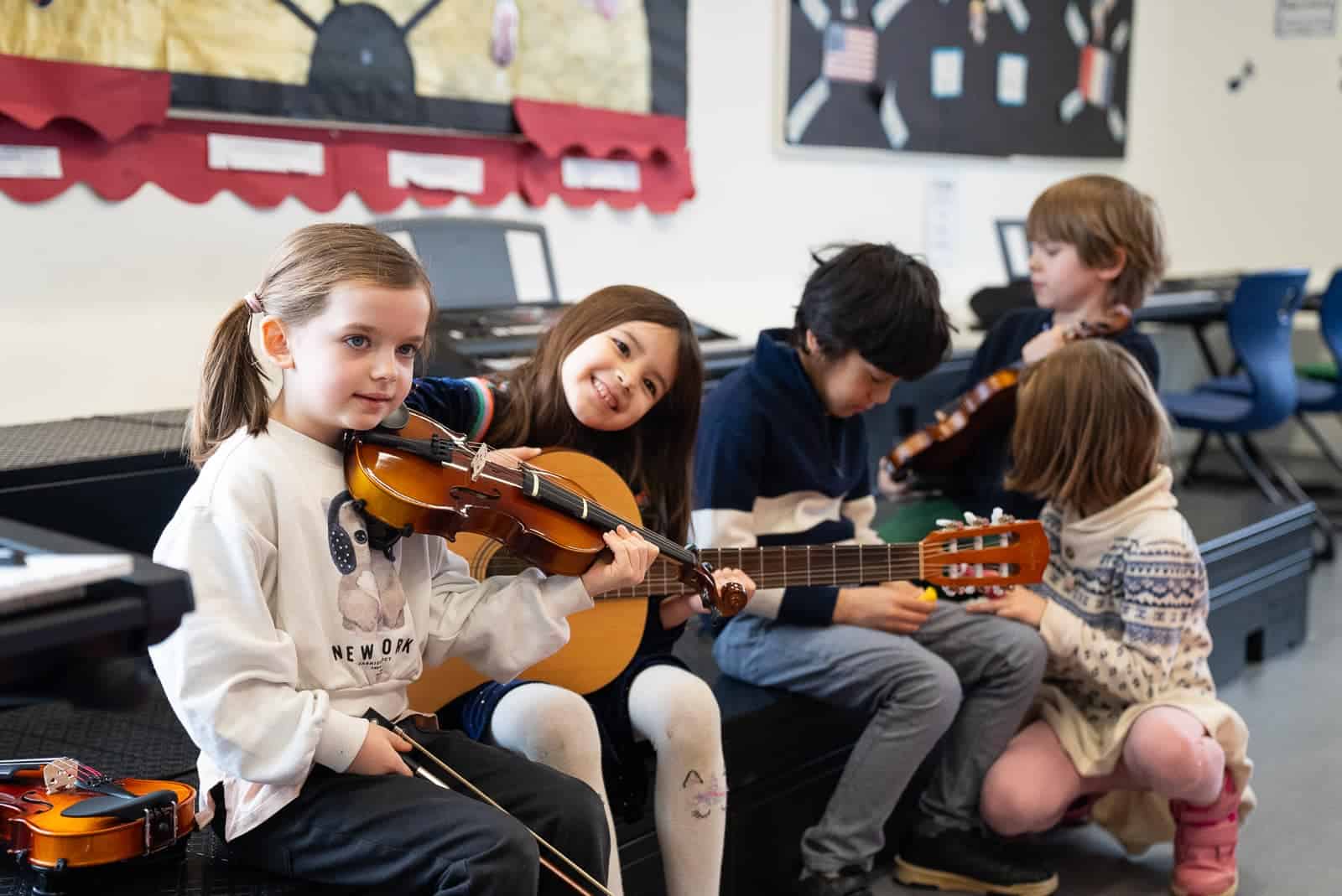 Young students playing guitars during music lesson at St George's International School, Luxembourg.
