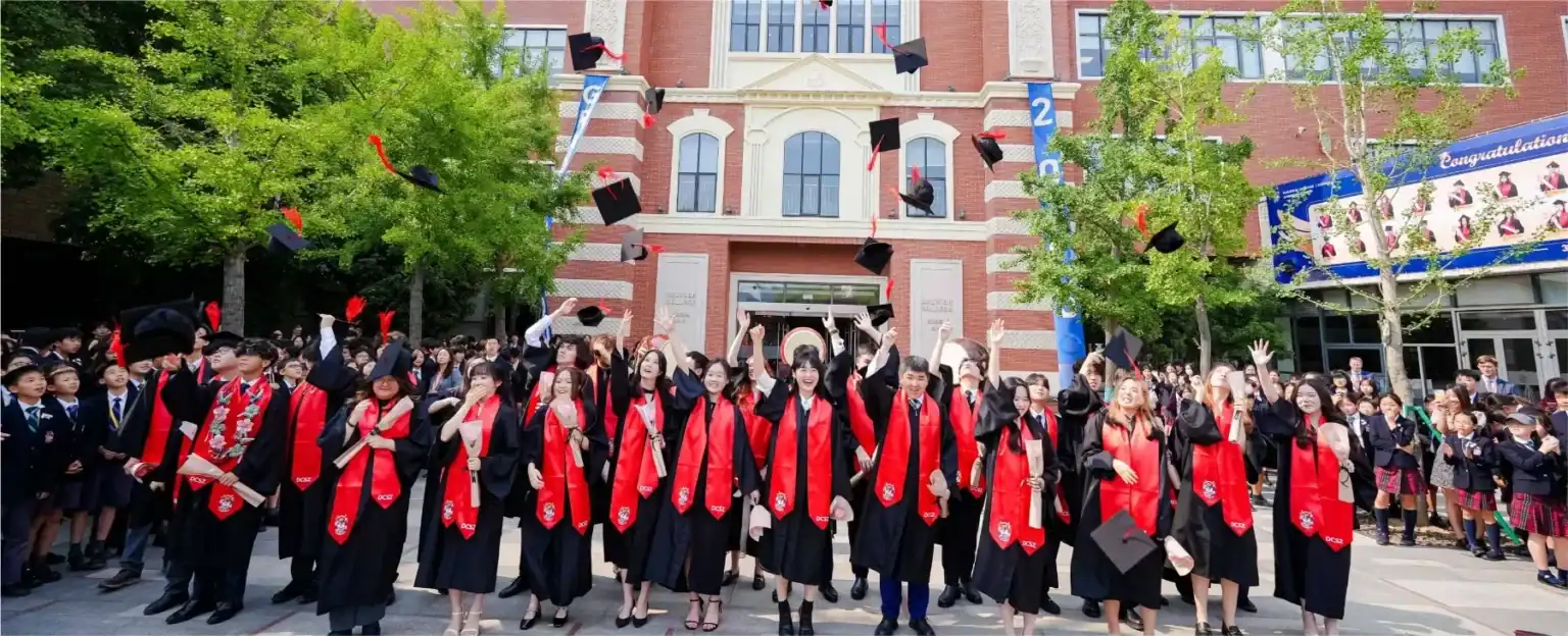 Graduates celebrating at Dulwich College Suzhou during graduation day.