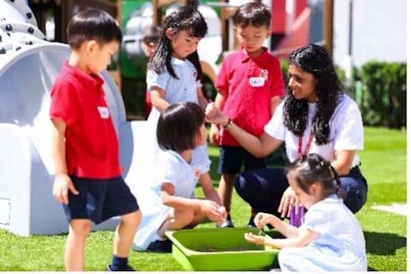 Children engaging in outdoor learning activity at Dulwich College Bangkok.