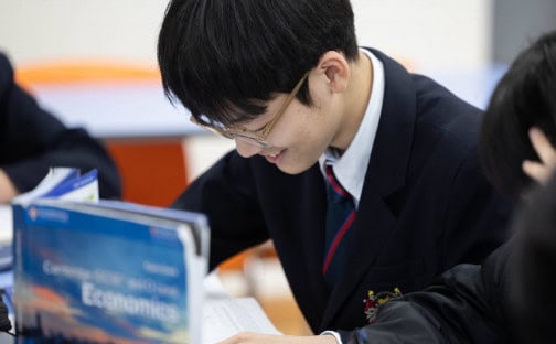 Student studying at Dulwich College Seoul, engaged in academic activities.