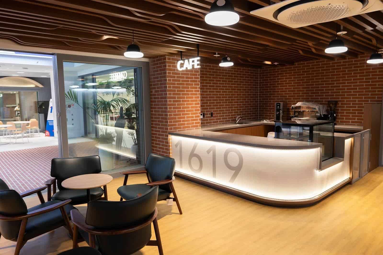 School cafeteria at Dulwich College Seoul with contemporary design and cozy seating.