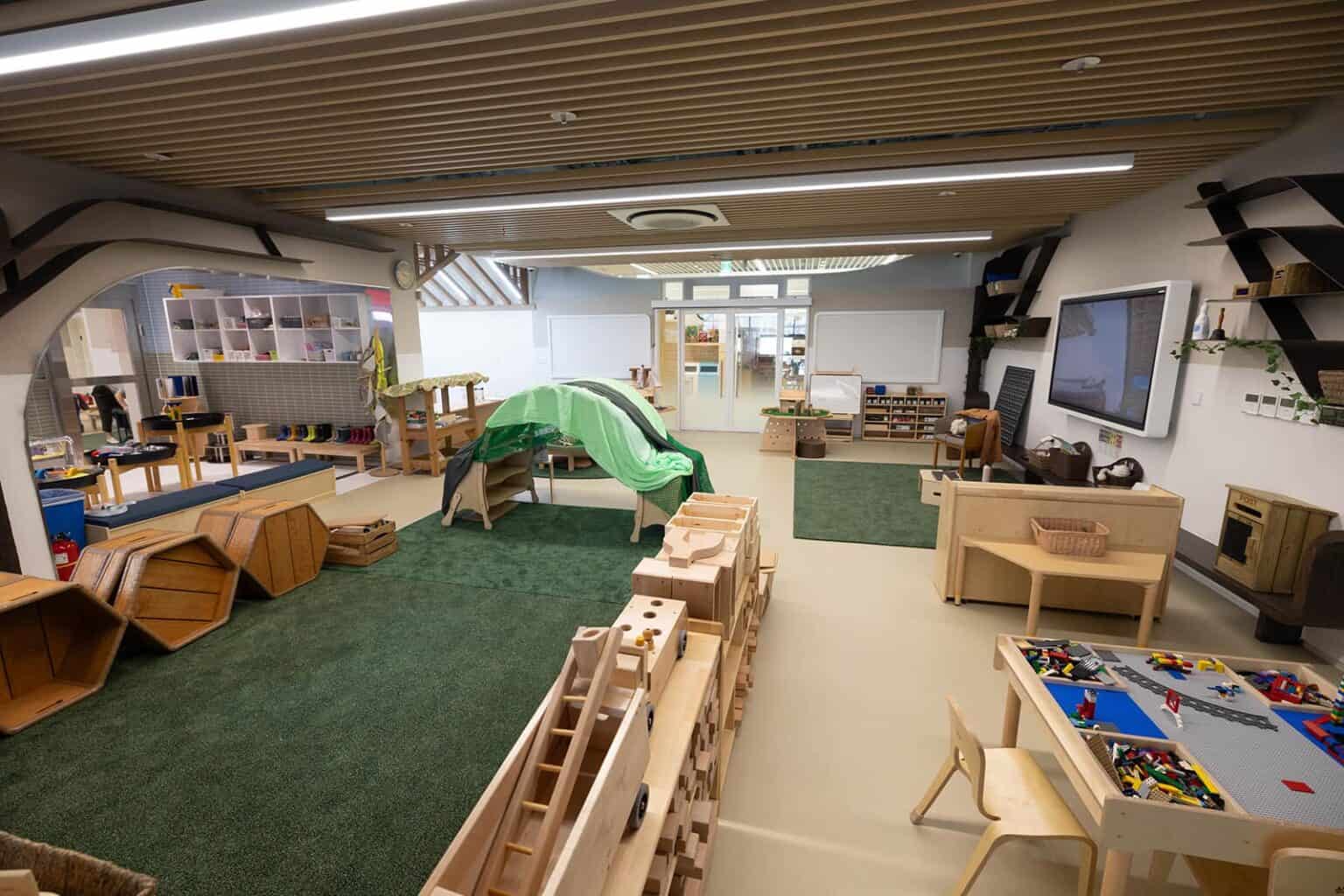 Indoor preschool classroom at Dulwich College Seoul with play areas and educational materials.