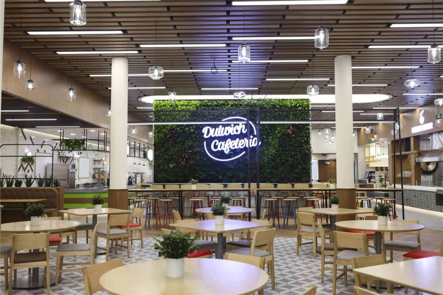 Modern Dulwich College Beijing cafeteria with stylish decor and comfortable seating.