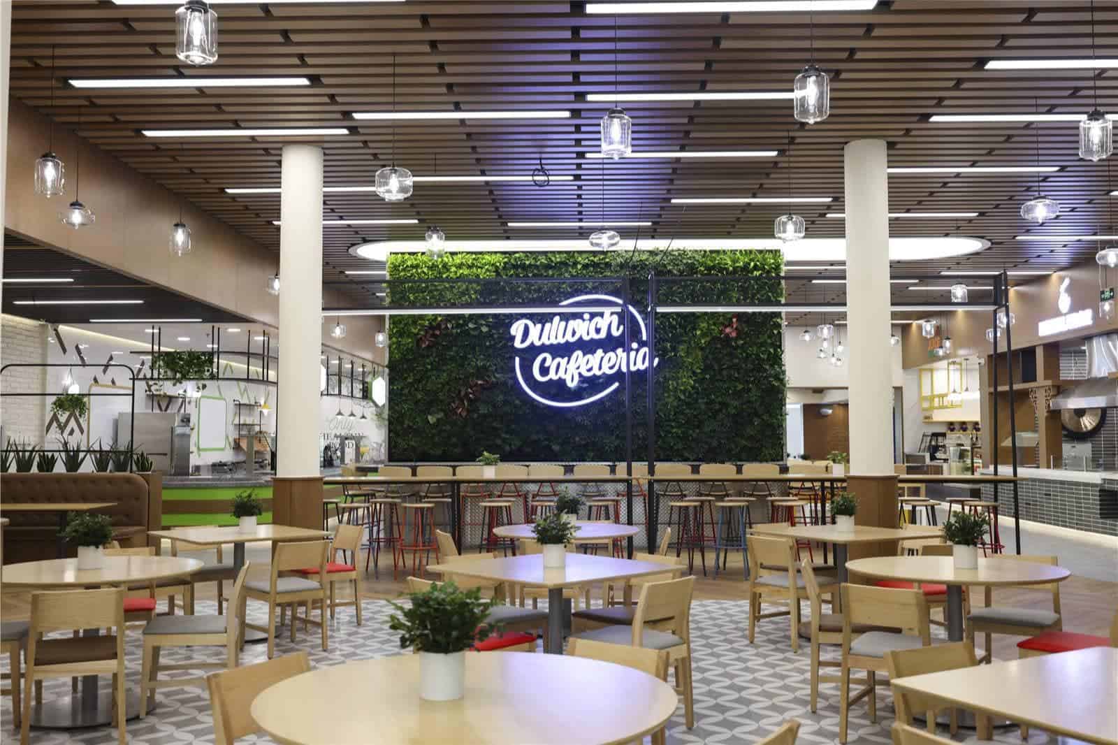 Modern Dulwich College Beijing cafeteria with stylish decor and comfortable seating.