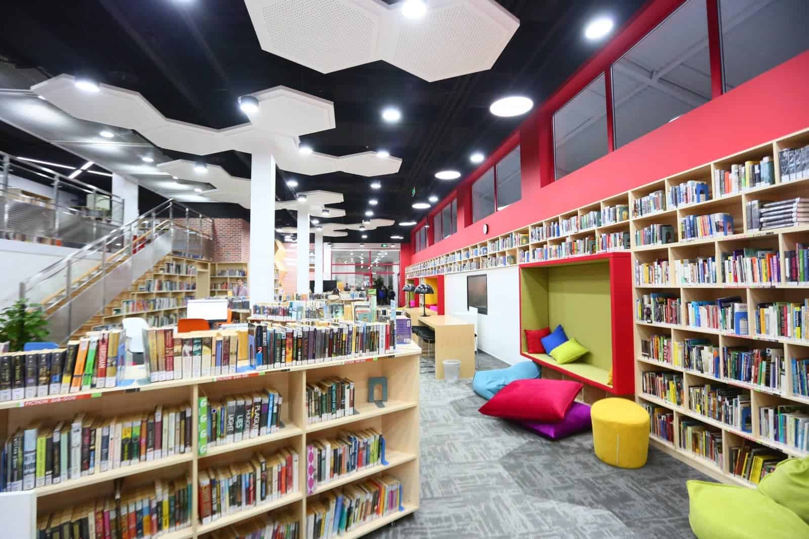 School library with colorful seating and extensive book collection at Dulwich College Beijing.