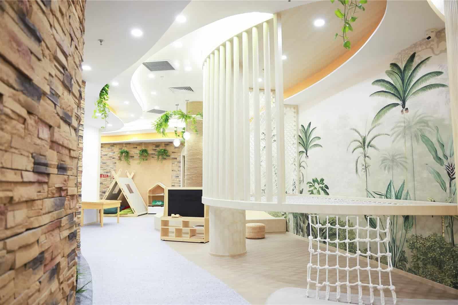 Bright, welcoming school lobby with tropical wall murals and natural decor elements.