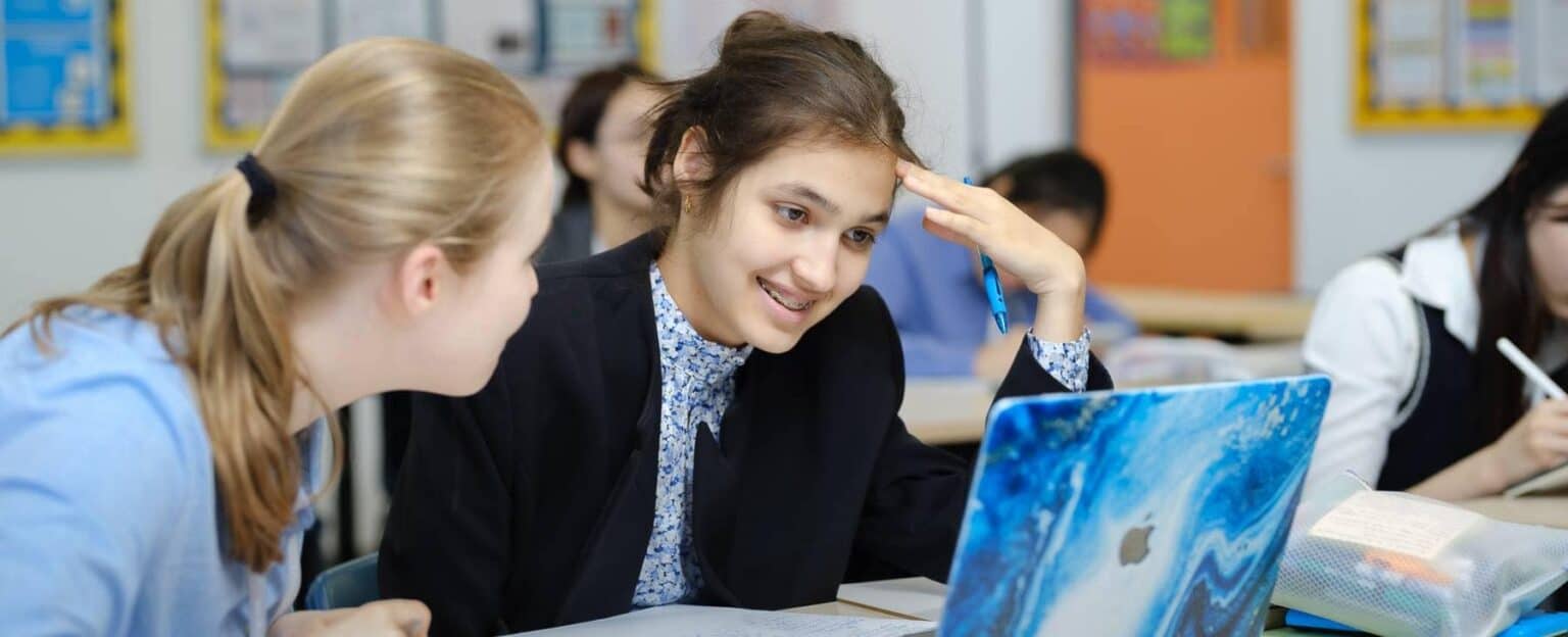 Students collaborating on a project in a modern classroom.