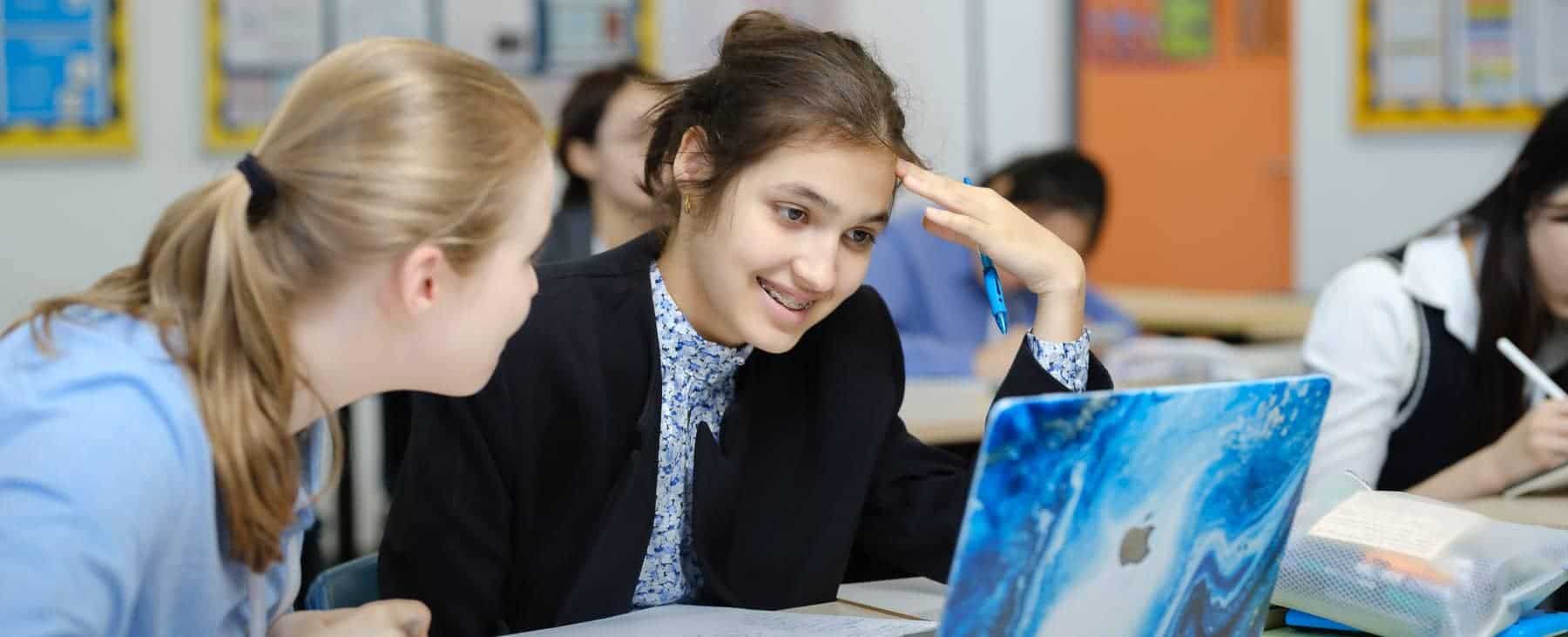Students collaborating on a project in a modern classroom.