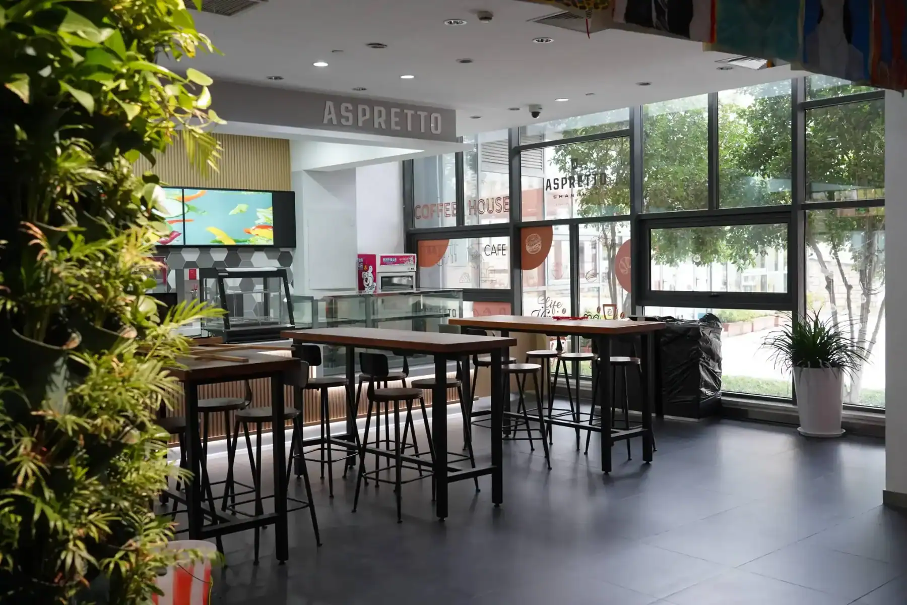 Bright, inviting school dining area with large windows and stylish furniture.